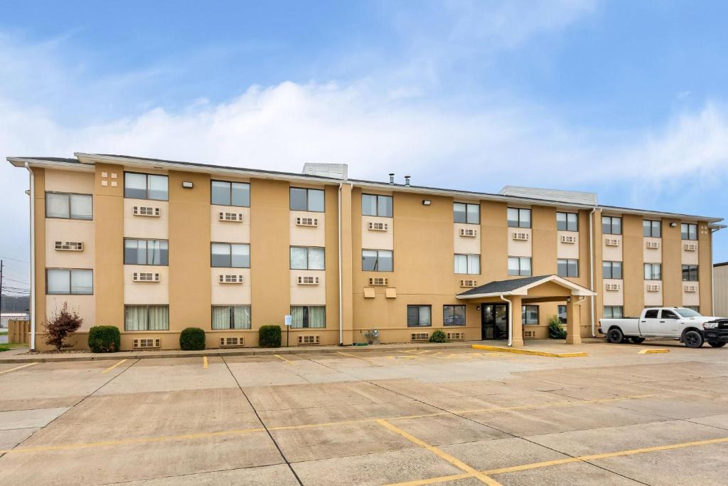 an apartment building with a parking lot at Super 8 by Wyndham Evansville East in Evansville