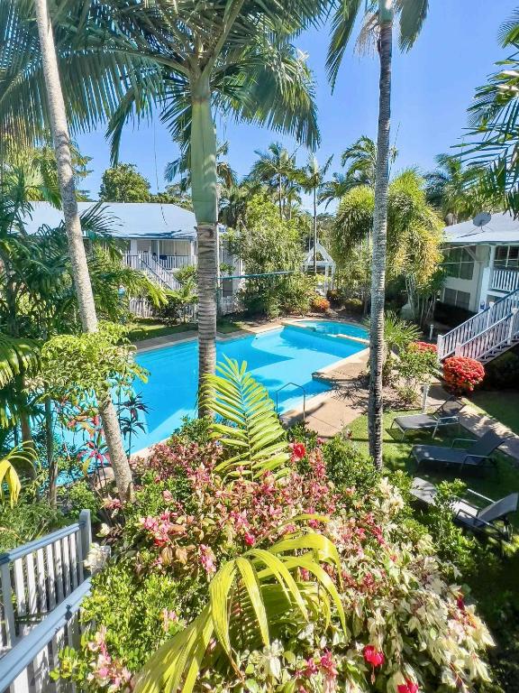 a view of the pool from the balcony of a resort at Mango Eden Villa in Airlie Beach