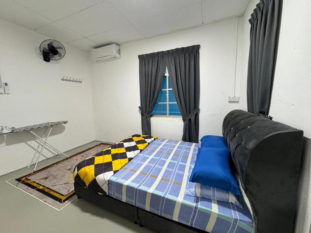 a bedroom with a bed and a window at DNH Nilam Puri Homestay Unit B in Kota Bharu