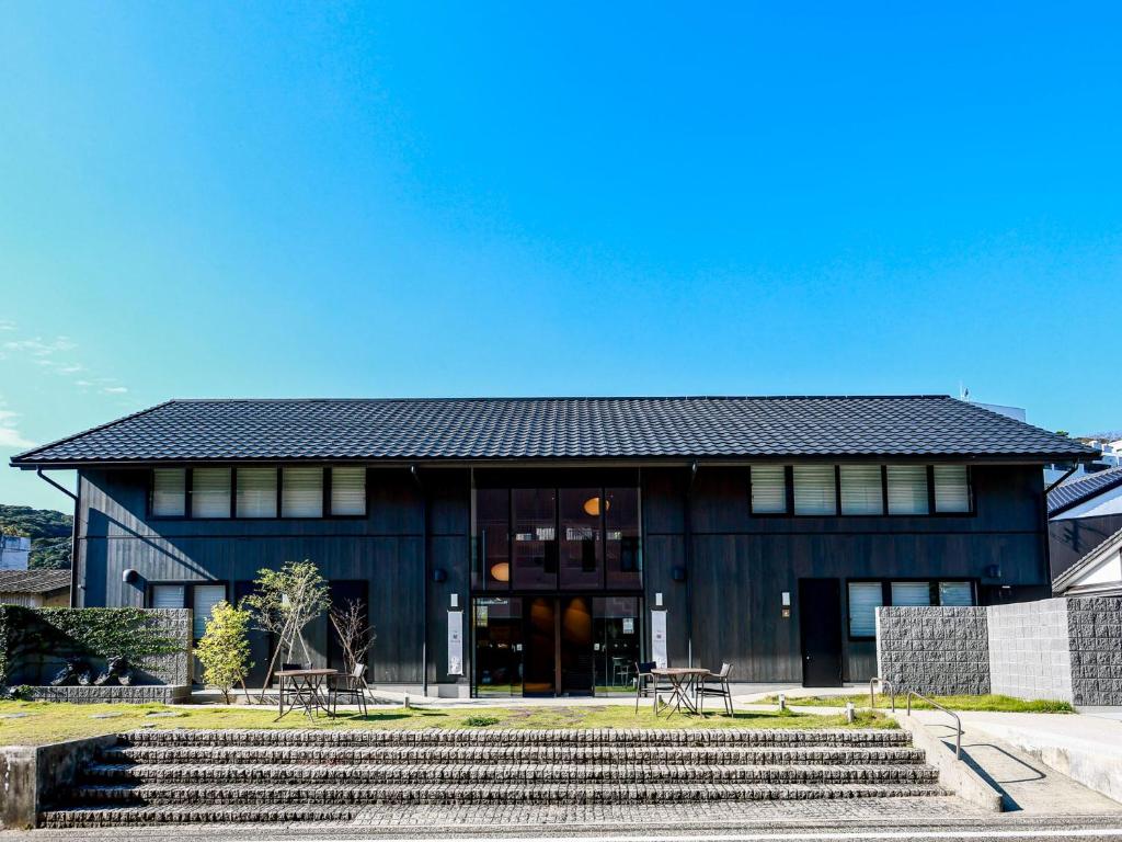 a black building with stairs in front of it at The 曜 Terrace in Hirado