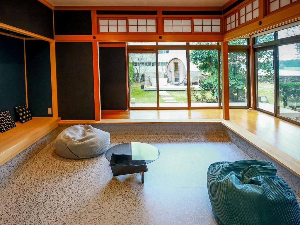 a living room with a couch and a glass table at 甚兵衛邸 in Hirado