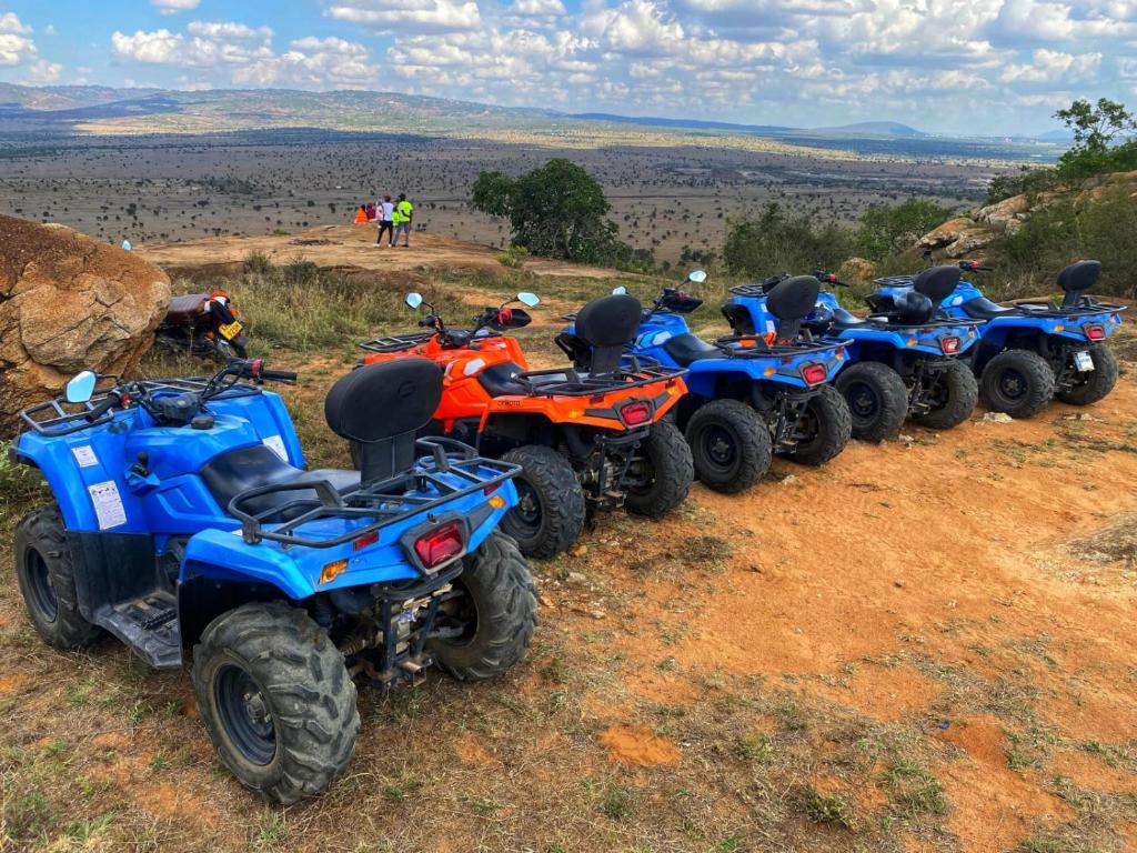 a row of atvs parked on a dirt road at Lukenya Motorcross in Machakos