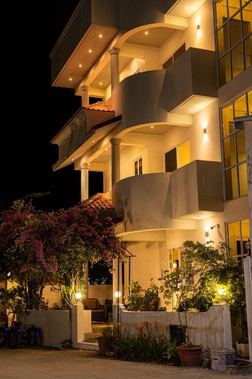 a large building at night with lights at Fen Villa in Dharavandhoo