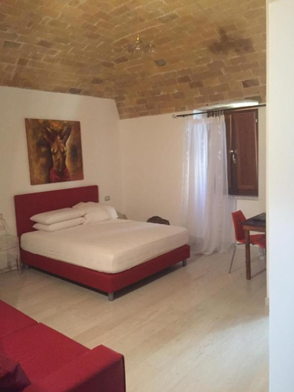 a bedroom with a bed and a table in a room at Residenza Hostaria del Pavone in Vasto