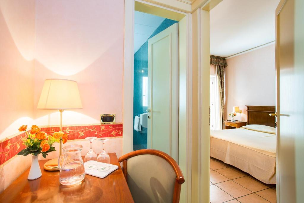 Postel nebo postele na pokoji v ubytování Hotel Santa Lucia
