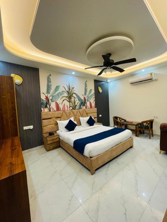 a bedroom with a bed and a ceiling fan at MK House in Greater Noida