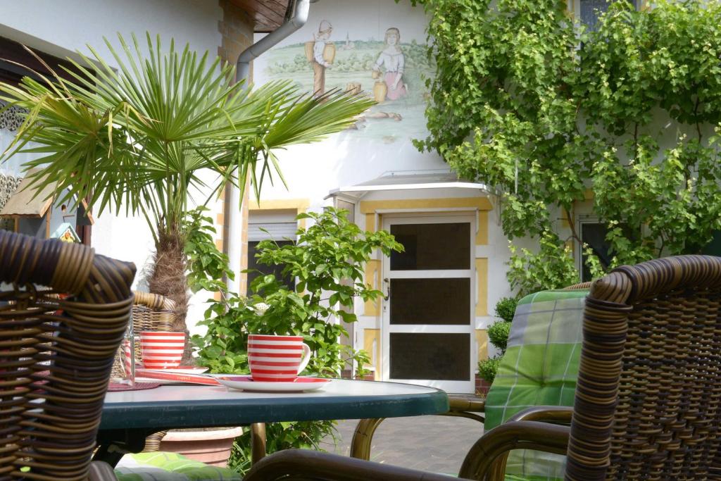 a table with cups and palm trees on a patio at Ferienhaus ODIN in Großräschen