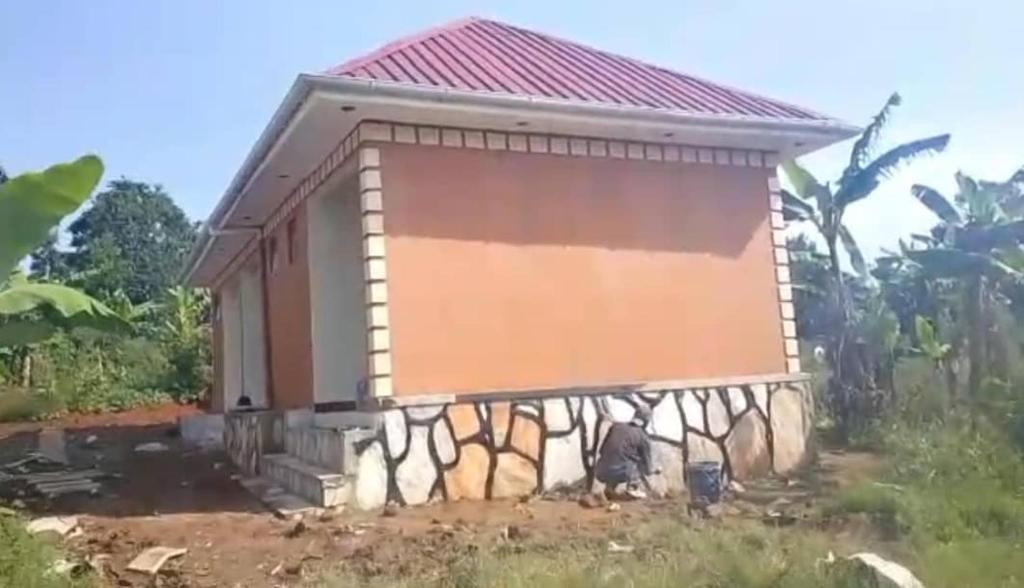 a small house with a fence around it at Jayson Housing in Wakiso
