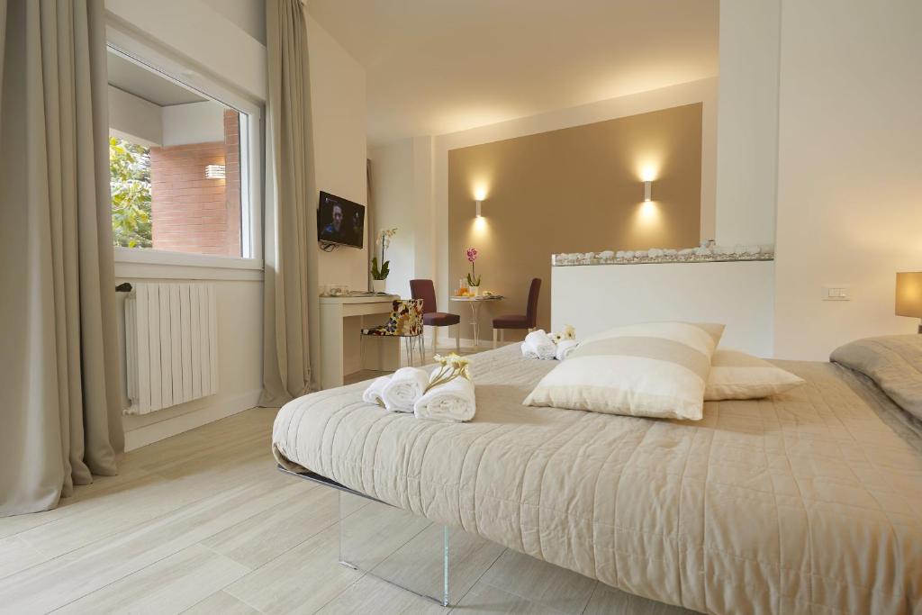 a bedroom with a large bed with white pillows at B&B Mondello Design in Mondello