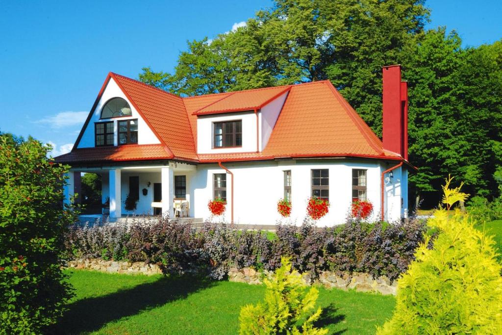 a white house with an orange roof at Holiday home, oasis of peace, Polanow in Pollnow