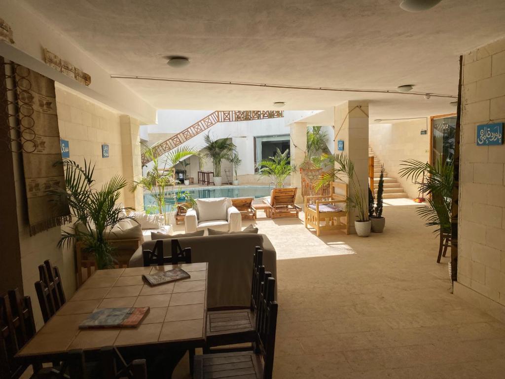 a large living room with a table and chairs at Blue Vision Diving Hotel in Marsa Alam City