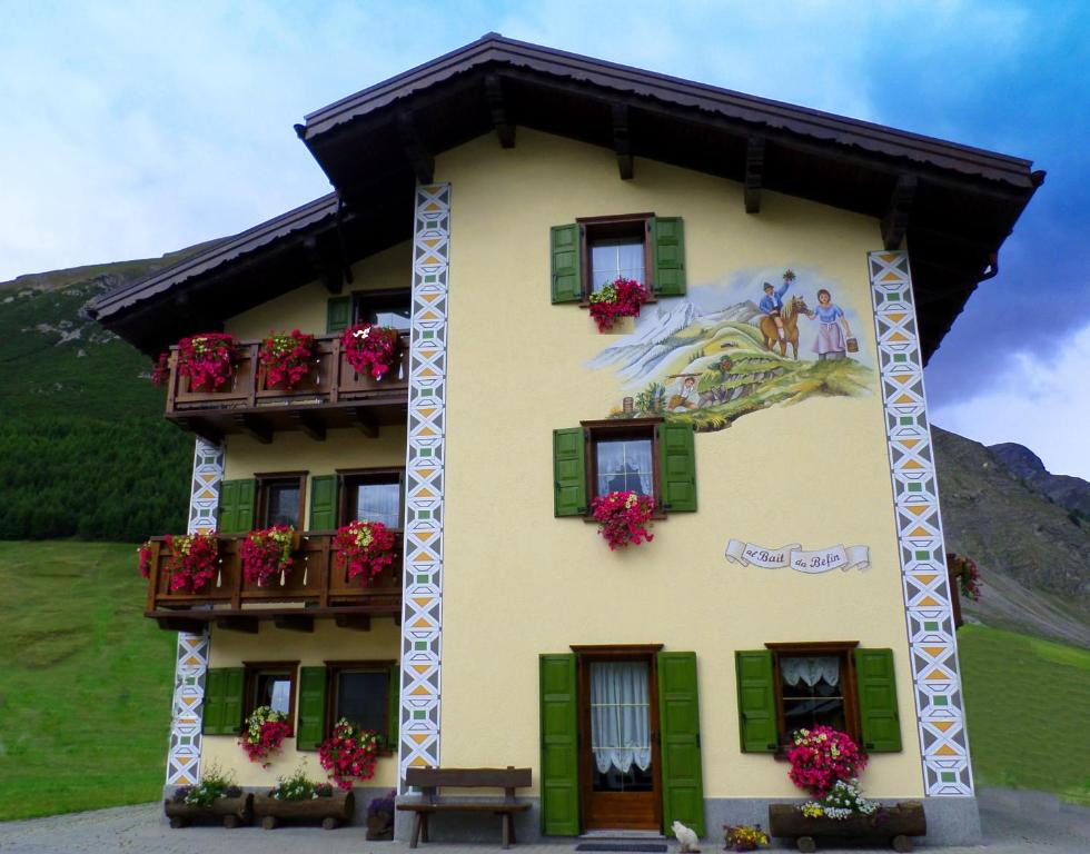 a building with a painting on the side of it at Bait da Befin in Livigno