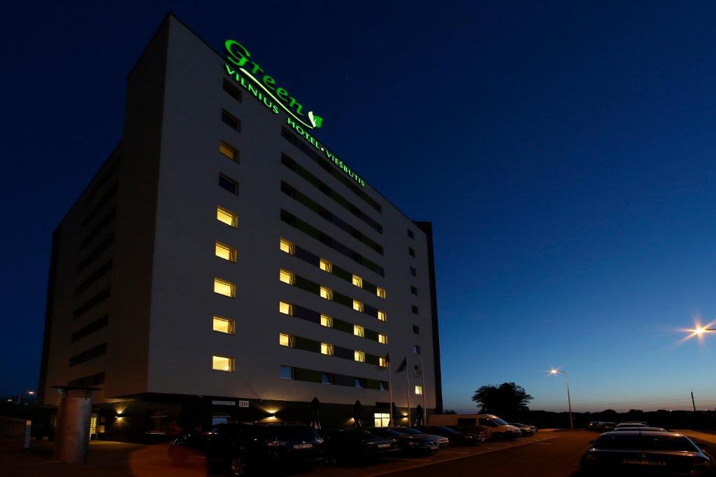 a hotel building with a sign on top of it at Green Vilnius Hotel in Vilnius