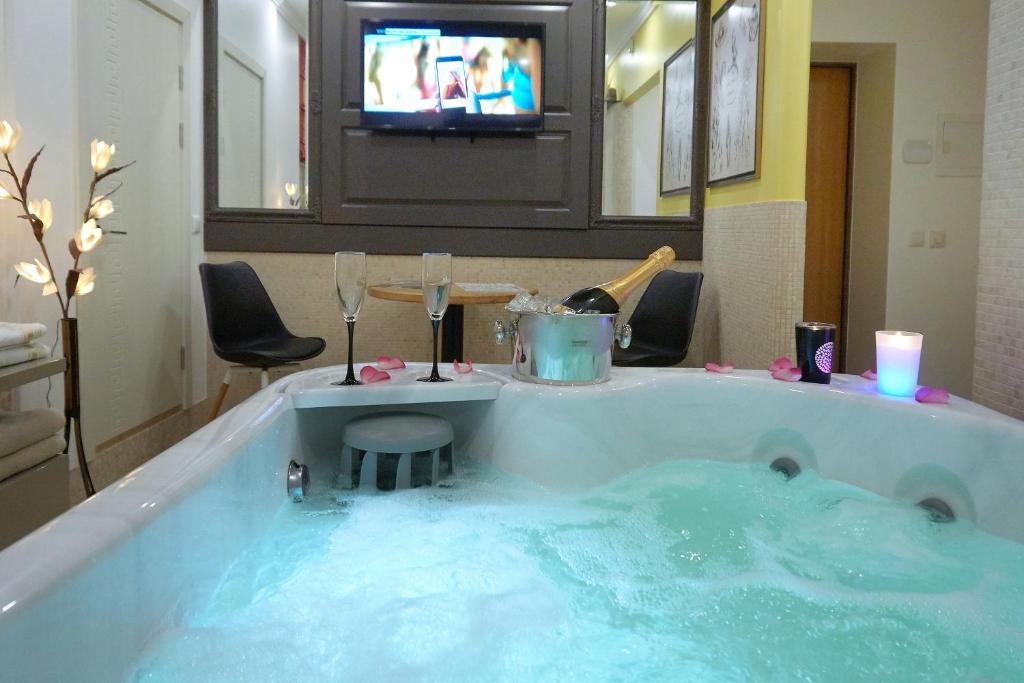 a large tub filled with blue water in a room at Luxury apartment in Old Town in Klaipėda
