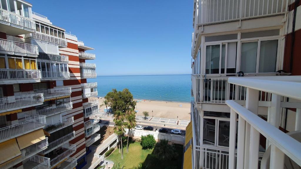a view of a beach from between two buildings at Las Brisas in Benicàssim
