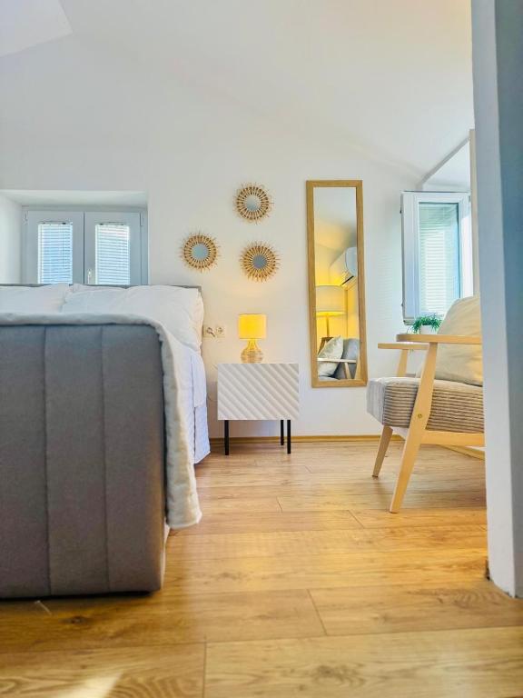 a bedroom with a bed and mirrors on the wall at St Peter's Heritage House in Trogir