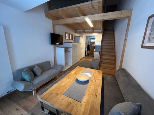 a living room with a couch and a wooden table at Appartement HochOben in Planneralm