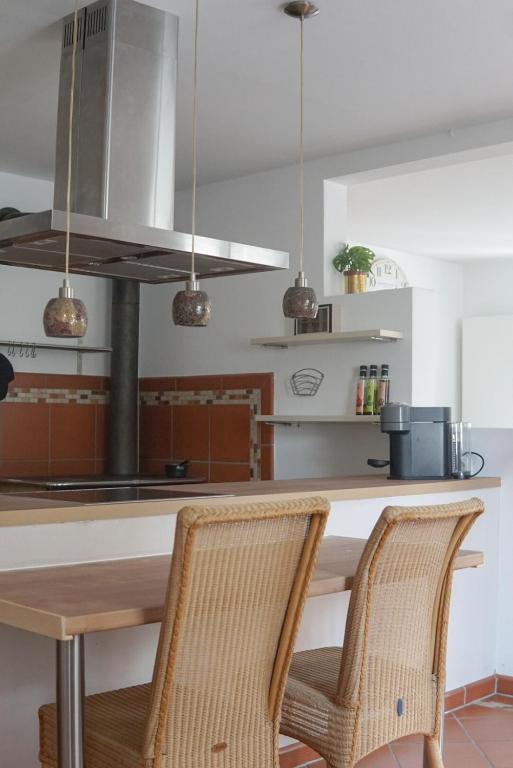 a kitchen with a wooden table and two chairs at FelsenSuite Panorama Essing in Essing