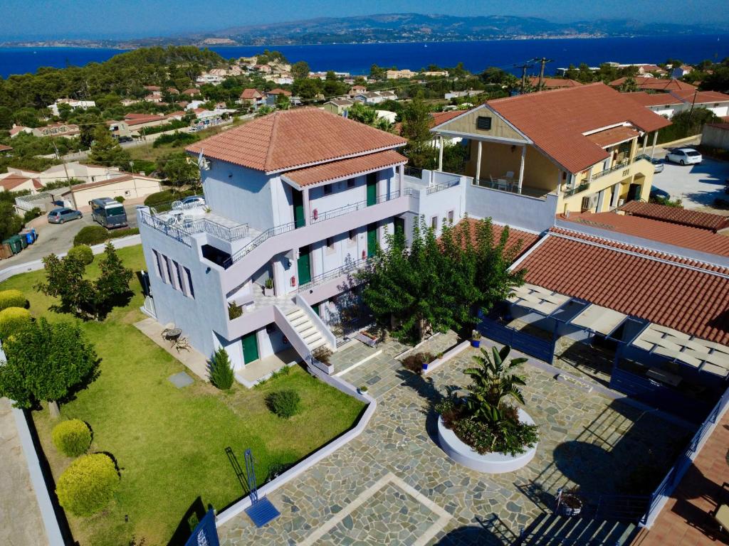 an aerial view of a large white house with a yard at Kekatos Studios in Lassi