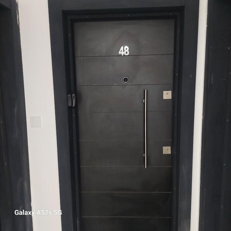 a black door with the number on it at Apartment Antonia - Gevgelija in Gevgelija
