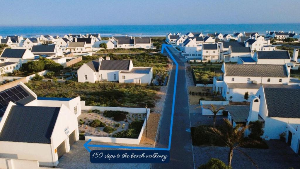 arial view of a city with white houses and the ocean at Saints at Sea in Dwarskersbos