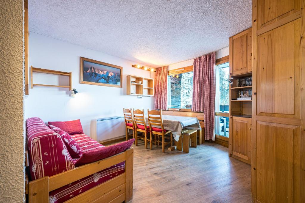 a living room with a table and a dining room at Appartement 46 - Les Coches in La Plagne Tarentaise
