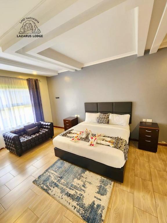 a bedroom with a king sized bed and a couch at Lake Naivasha Lazarus Lodge in Naivasha