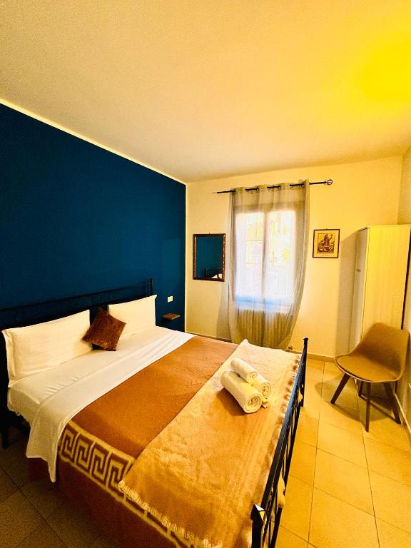 a bedroom with a large bed with a blue wall at Hotel Canal Salieri in Venice