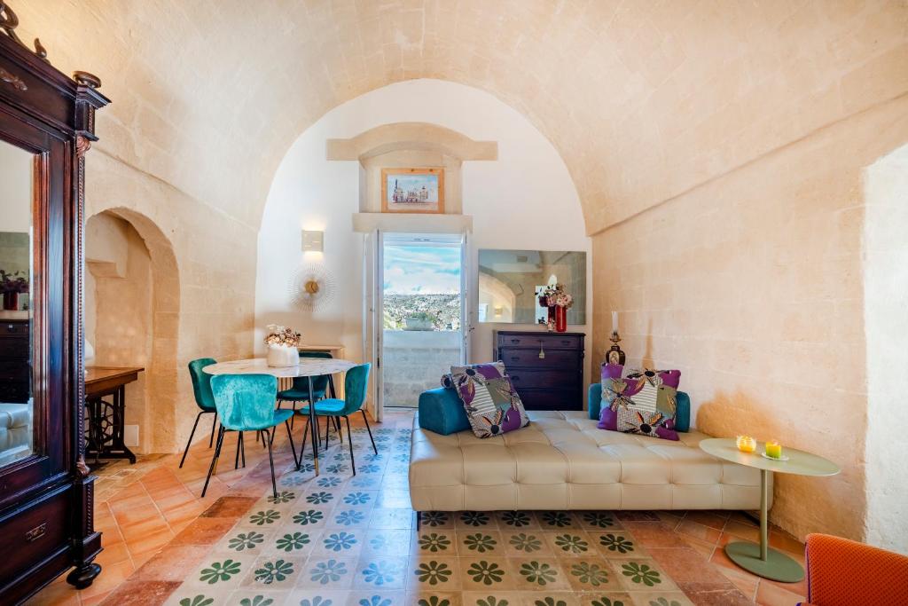 a living room with a couch and a table at Suite San Pietro - Sassi di Matera in Matera