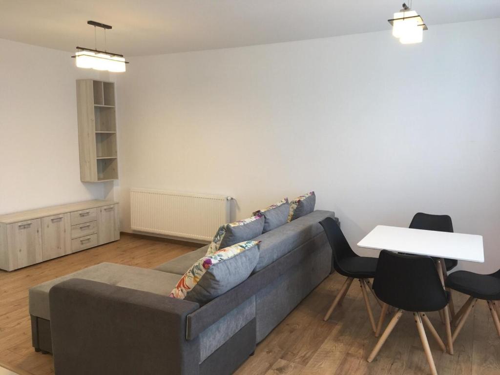 a living room with a couch and a table at Two rooms Vivo Metro Amethyst in Floreşti