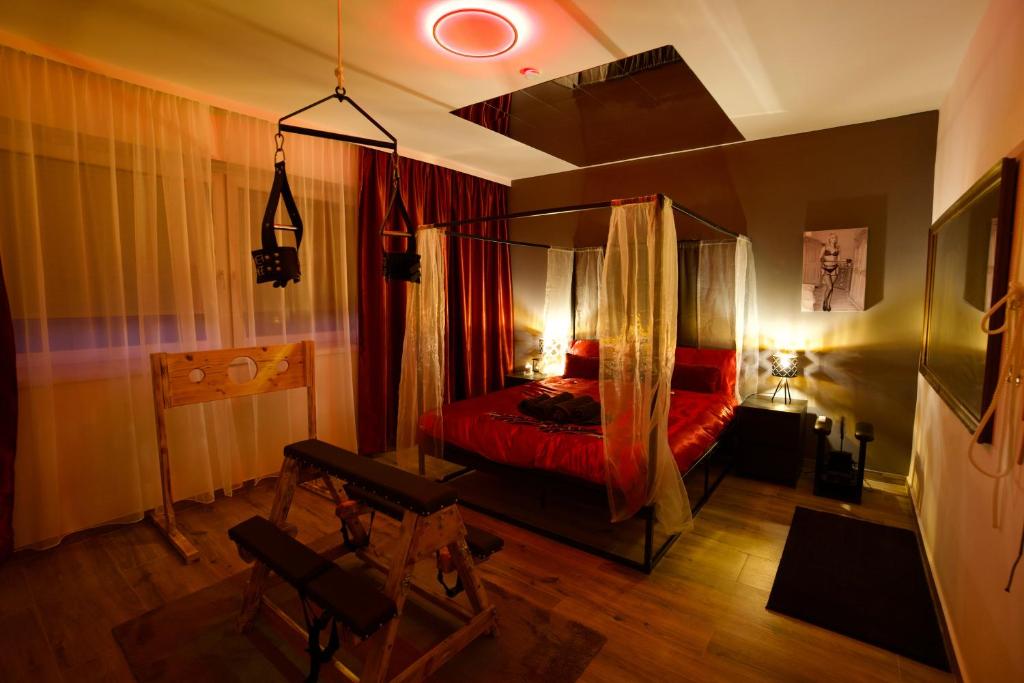 a bedroom with a red bed with a canopy at RK Private Residence in Trautmannsdorf an der Leitha