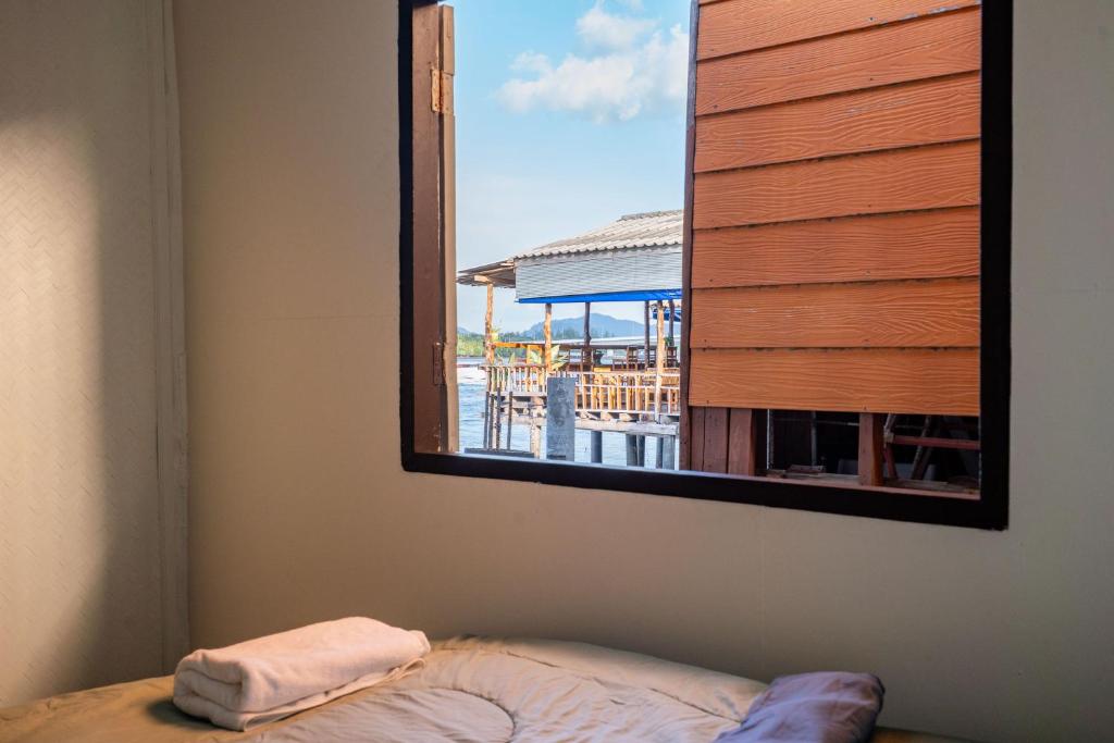 a mirror on the wall of a room with a window at Searyn Lanta in Ko Lanta