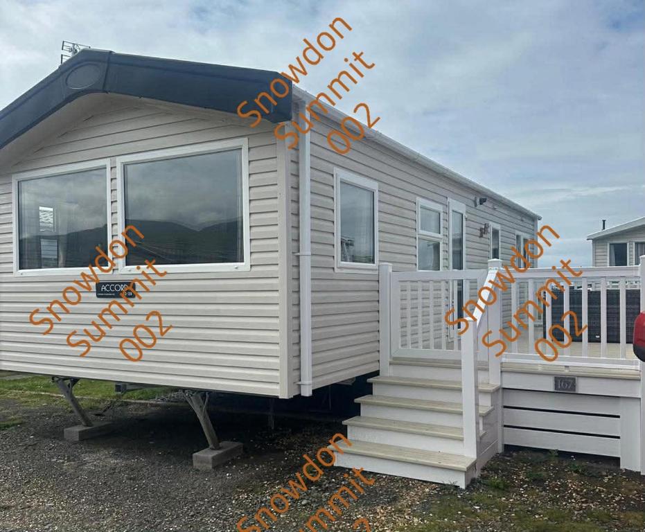 a mobile home with orange writing on the side of it at Snowdon Summit 002 in Barmouth