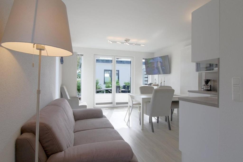 a living room with a couch and a table at KW4 Haus Anna in Dorum-Neufeld