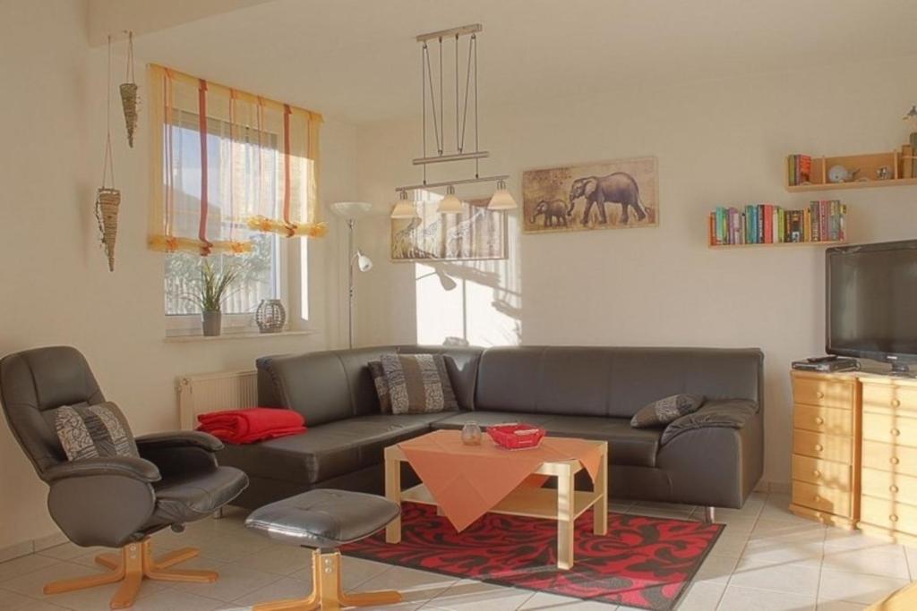 a living room with a couch and a table at LT35 Bungalow Moritz in Dorum-Neufeld