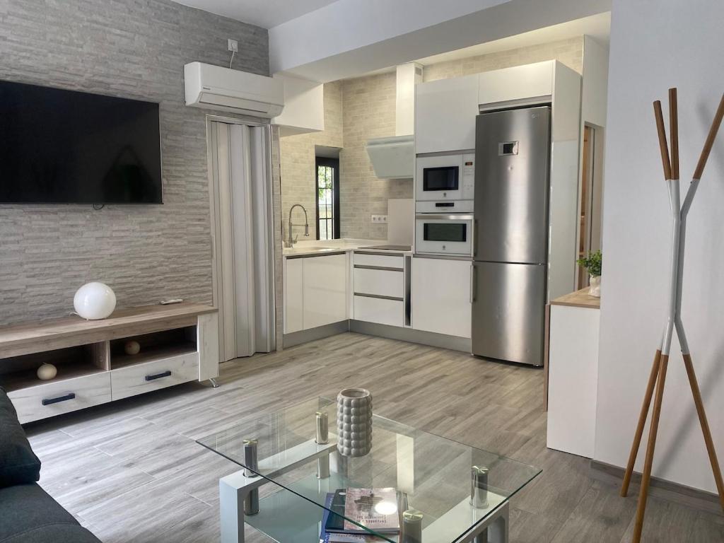 a kitchen with white cabinets and a stainless steel refrigerator at Casita Mona Marcoin in Toledo