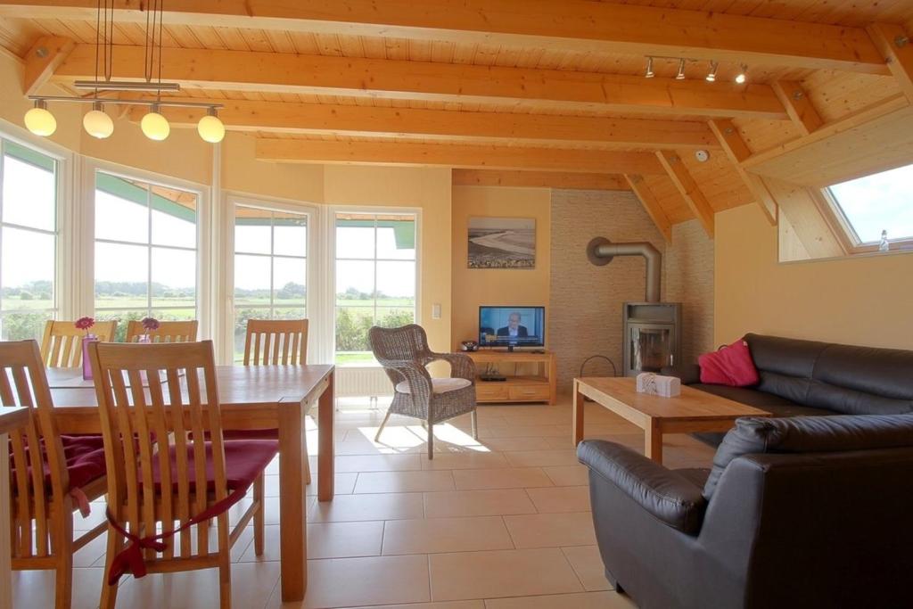 a living room with a table and a couch at SV3 Mellumplate 56 in Dorum-Neufeld