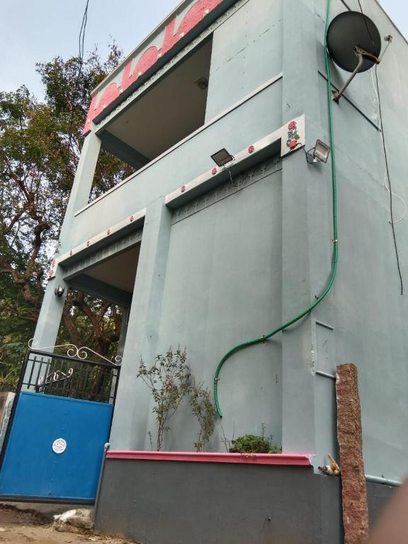 a building with a green hose on the side of it at Nandy Delight Homestay in Kanyakumari