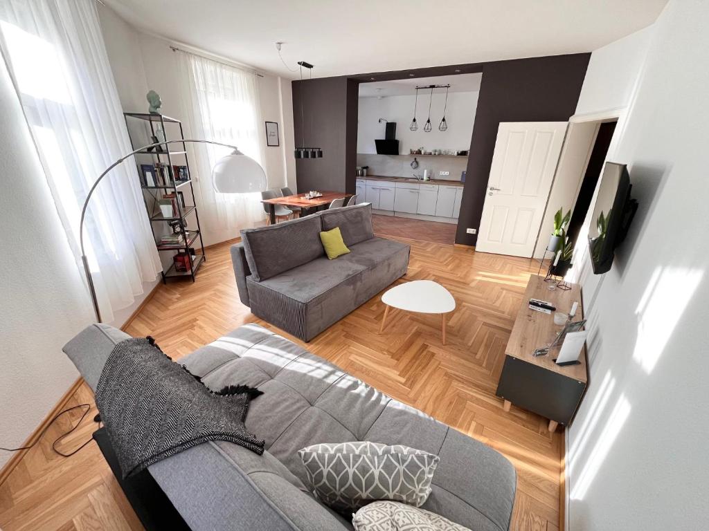 a living room with a couch and a table at ✪ FirstClass-Apartment in Leipzig-Gohlis ✪ in Leipzig