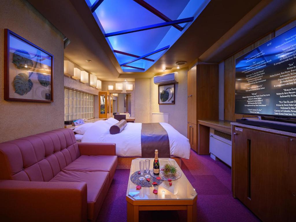 a hotel room with a bed and a tv at Water Hotel Mw 岩槻 -Adult only- Love Hotel in Saitama