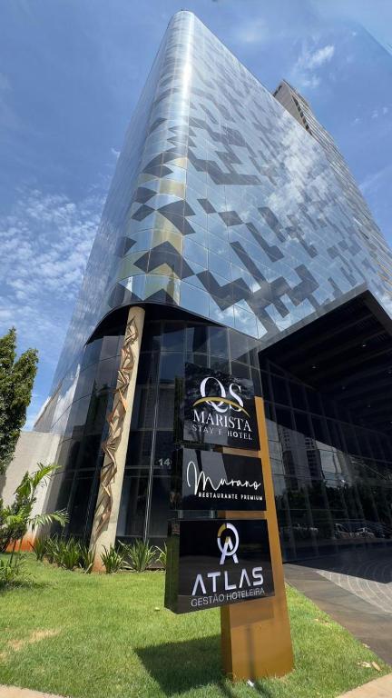 a building with a sign in front of it at QS Marista Hotel by Atlas in Goiânia