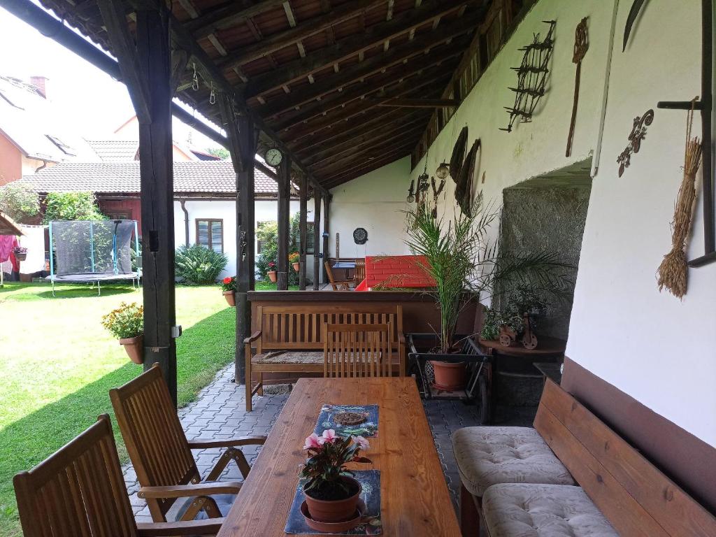 a patio with a wooden table and chairs at Apartmány Somora in Doksy