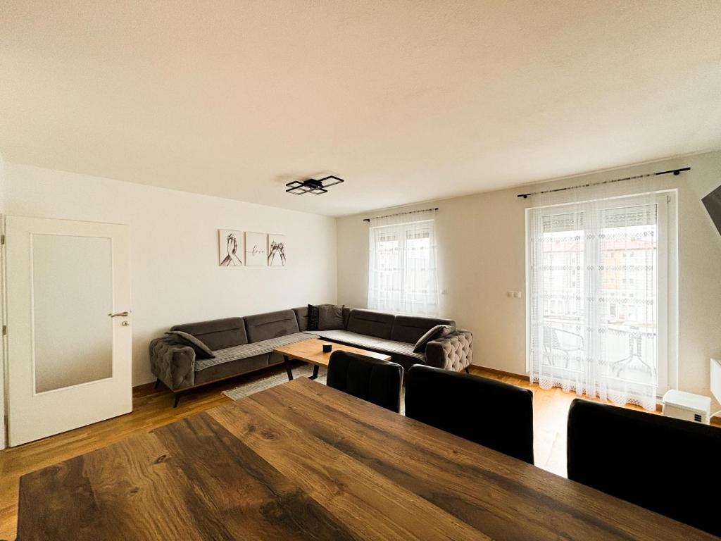 a living room with a couch and a table at Apartman Sučić in Livno