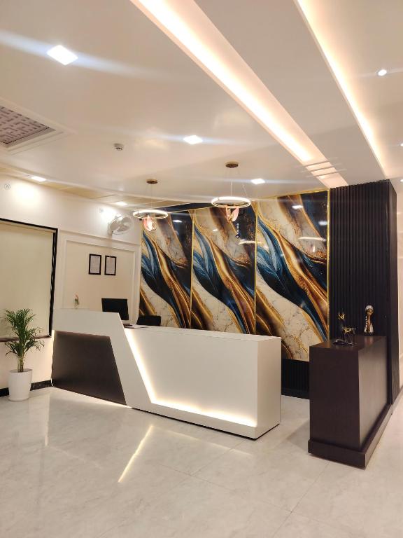 a lobby with a large painting on the wall at Status Club in Hardoī