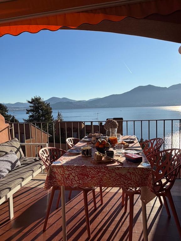 a table on a deck with a view of the ocean at Lavinia in Oggebio