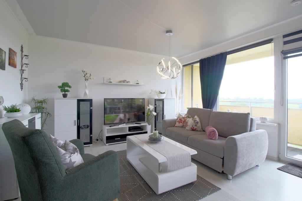 a living room with two couches and a tv at Apartment 256 in Hohegeiß