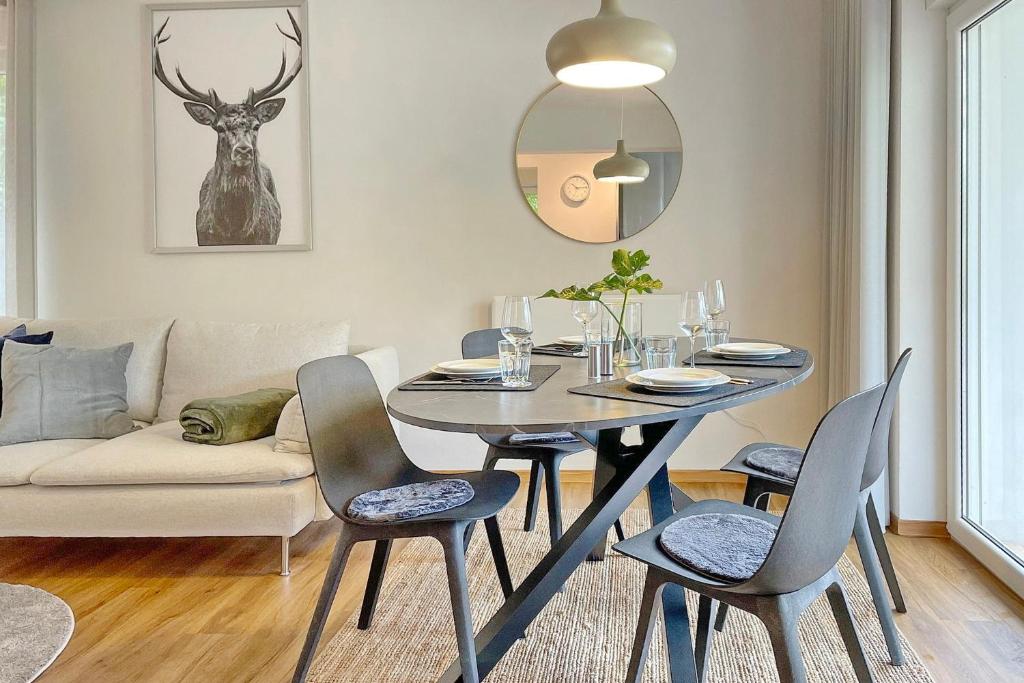 a dining room with a table and chairs and a couch at Admiral in Lübbenau