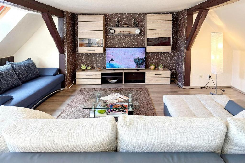 a living room with a couch and a tv at An der Postmeilensäule in Lübbenau