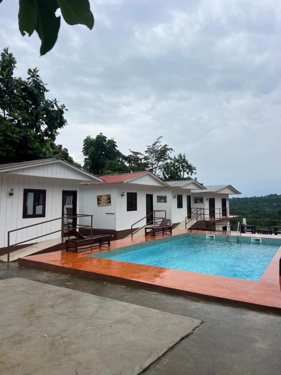 a large swimming pool in front of a building at Resort Ideal Forest in São Tomé