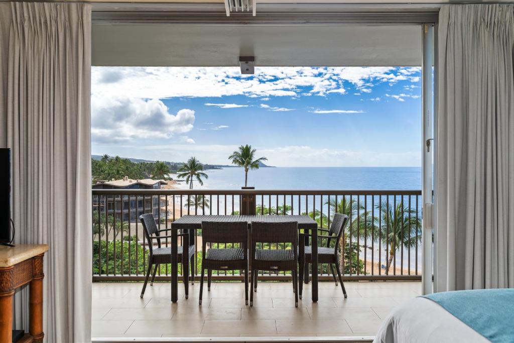 a dining room with a view of the ocean at Mana Kai 611C in Wailea